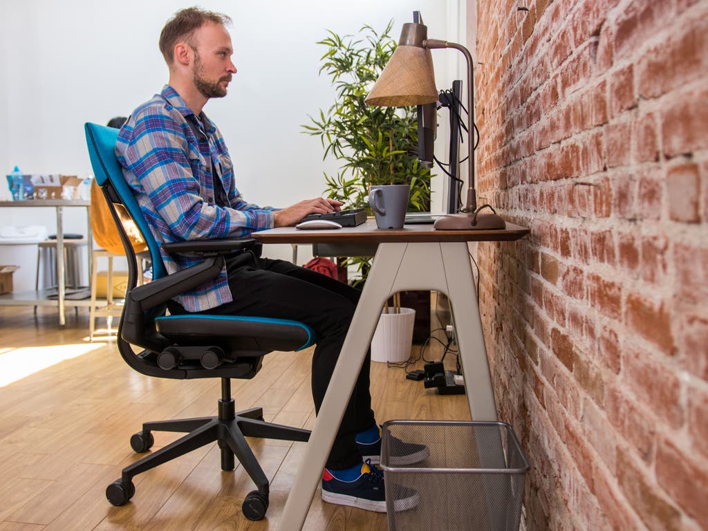 Modern ergonomic home office setup with desk, chair, and monitor