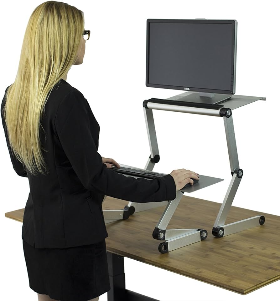 Woman using adjustable height standing desk converter